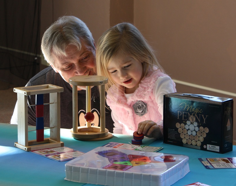 Grandparent and child participating in library activity