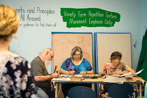 Older adults participate in a wood burning workshop
