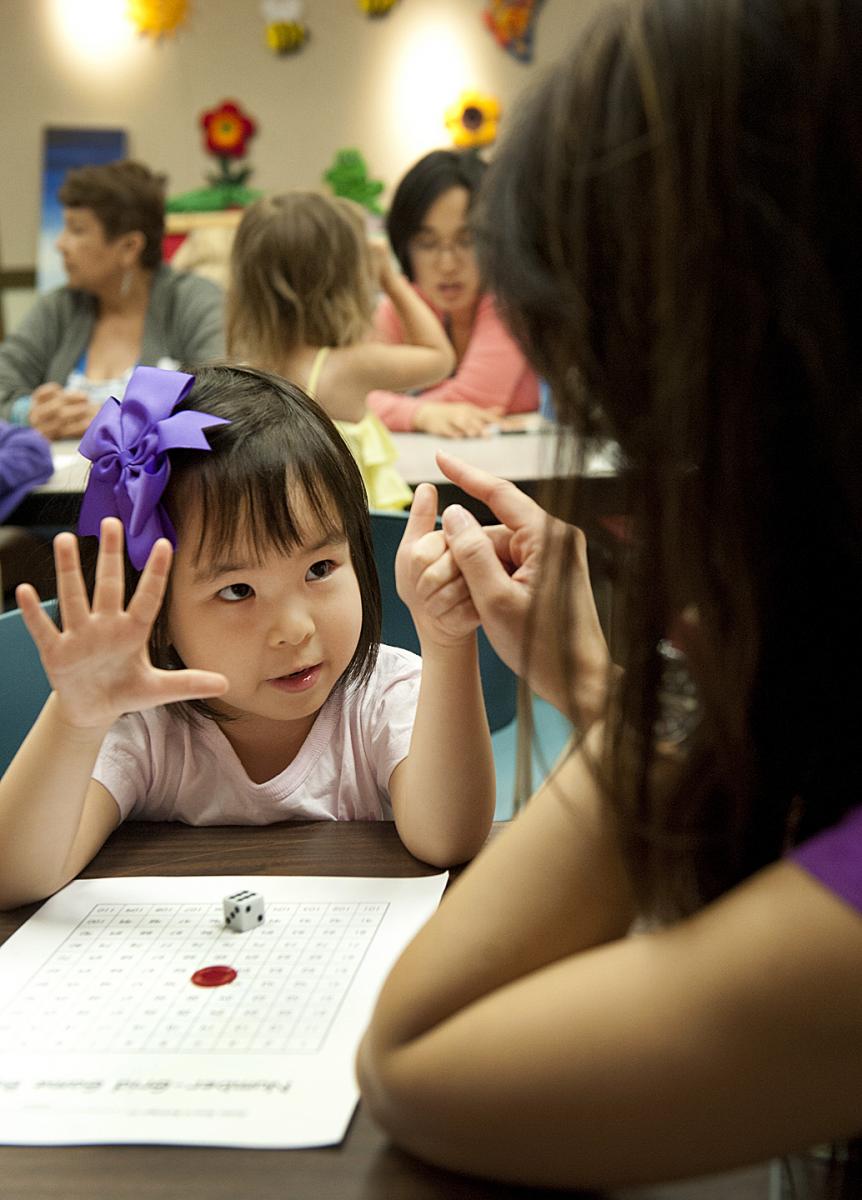 Pre-school student counts with fingers