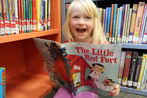 Little girl reading, Delta County Libraries