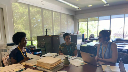 Interns sitting around a table.