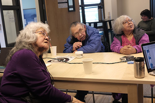 Three people sitting at a table