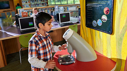 School-age students interact with science installations in the Mayfield Branch youth space. Photo: Cuyahoga County Public Library, OH.