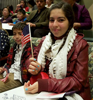 A young girl holding a flag.