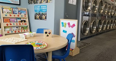 a table and library books next to laundry machines