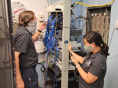  two professional IT technicians in a server room