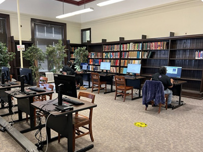 library room with bookshelves, chairs and tables