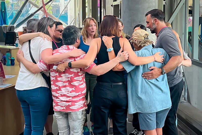 Group of people standing in a huddle 