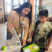 Intern assisting library patron