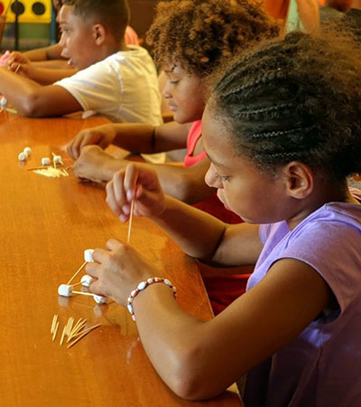 Children participate in table activities with the Summer Library Program in Ohio