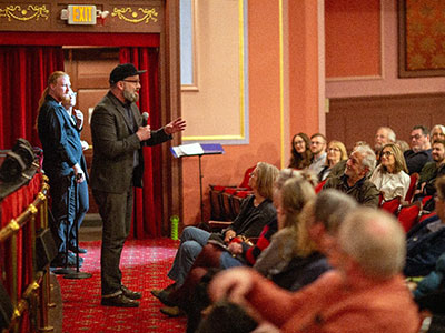 An audience watching a theater project.