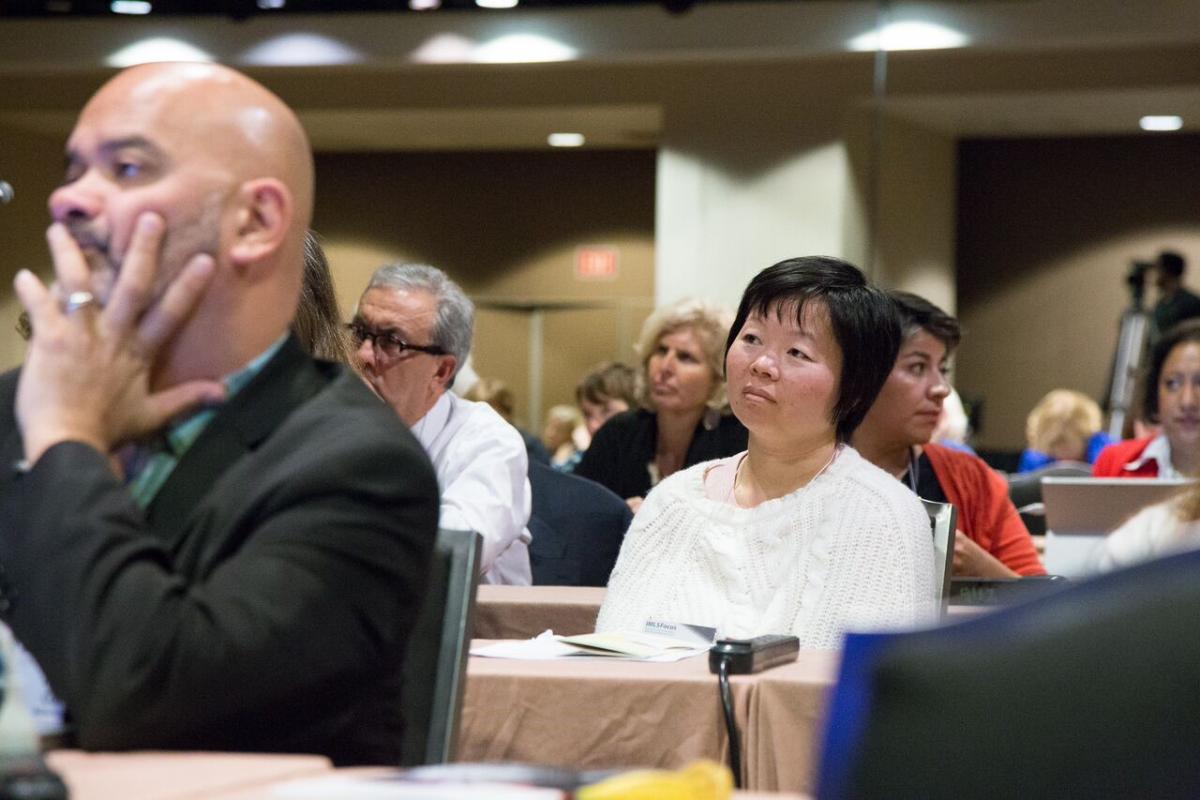 Participants listen to plenary speakers.