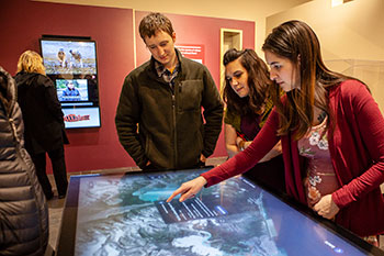 Visitors use the interactive map at the Sealaska Heritage Institute’s exhibit “Our Grandparents’ Names on the Land”.