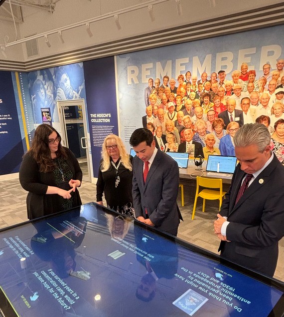 Keith Sonderling (center) reviews exhibit at Holocaust Documentation and Education Center in Dania, Florida.
