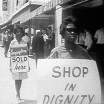 In 1962, African American women in Albany, Georgia, are arrested for picketing in front of Albany City Hall and nearby Lane Drugs.