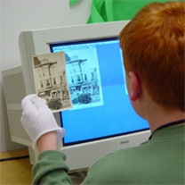 A student prepares a historic photograph to be uploaded into the Maine Memory Network.