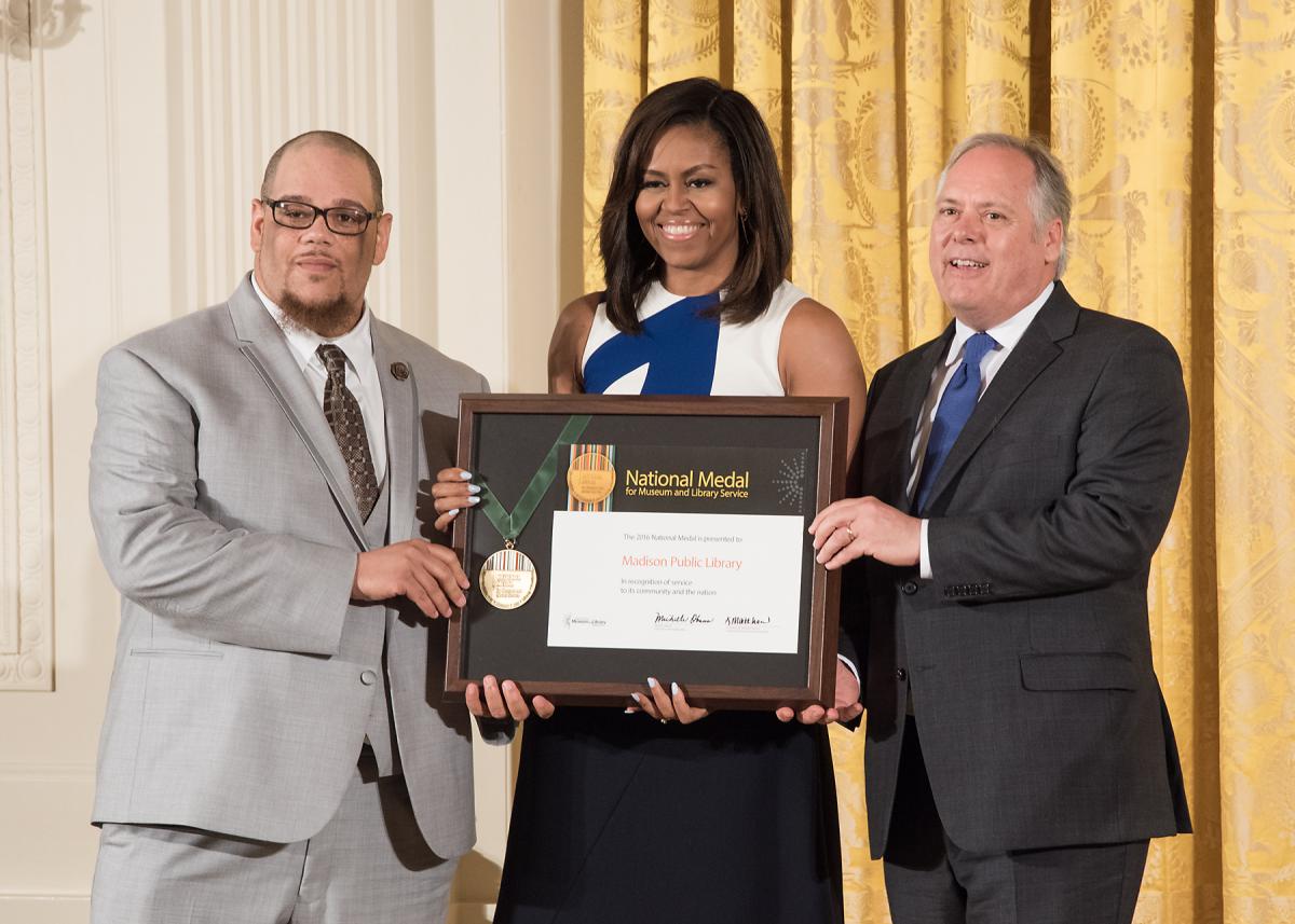 Community member Rob Franklin and Madison Public Library Director Greg Mickells celebrate after accepting the award, presented by First Lady Michelle Obama. 