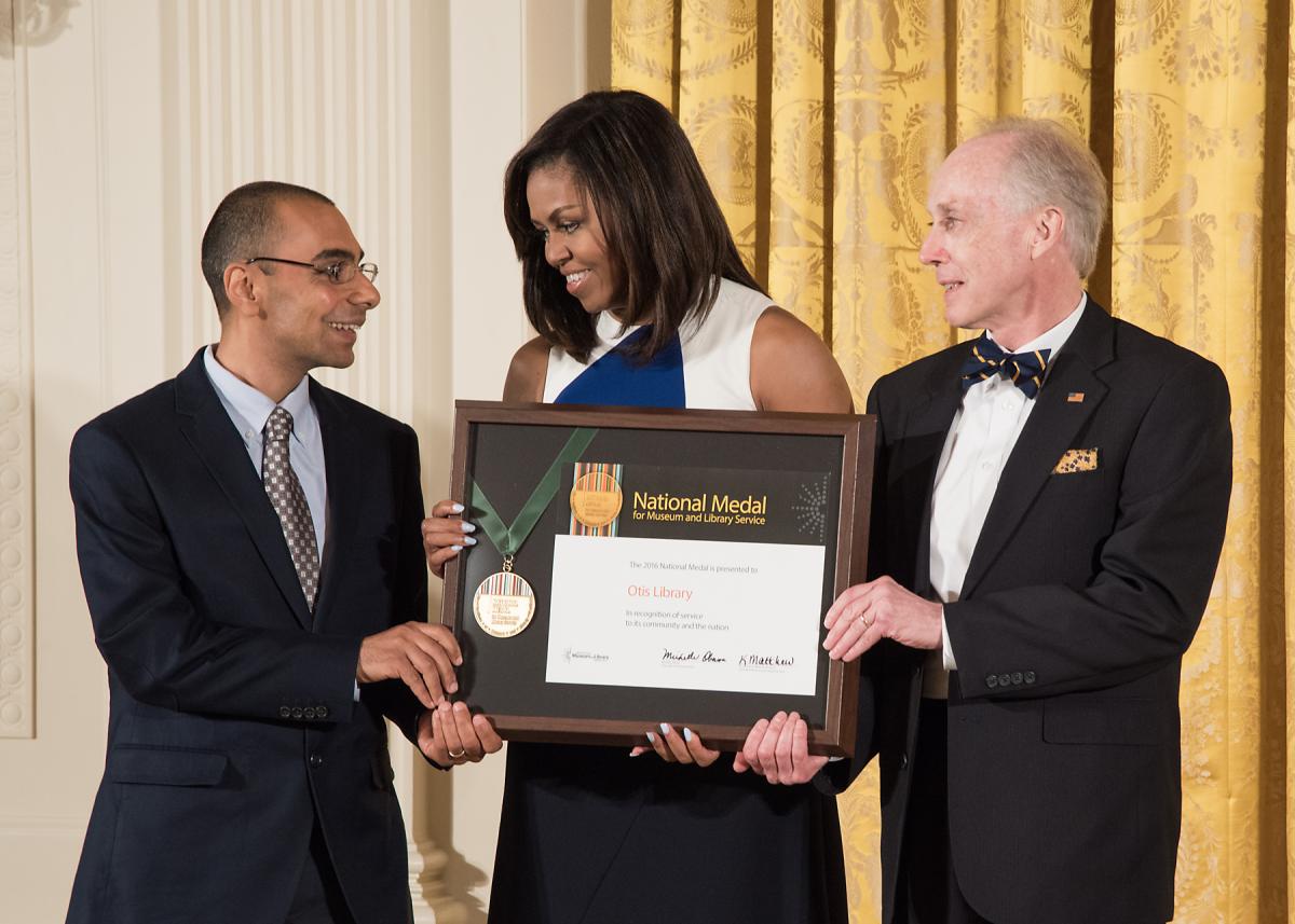 Community member Baseem Gayed and Otis Library Executive Director Bob Farwell accept the award from First Lady Michelle Obama. 