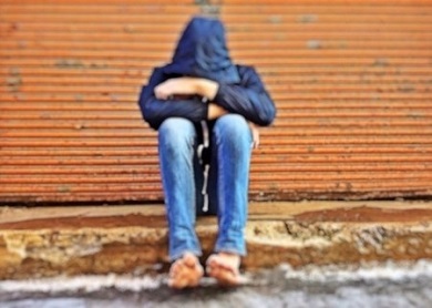 youth sitting on curb