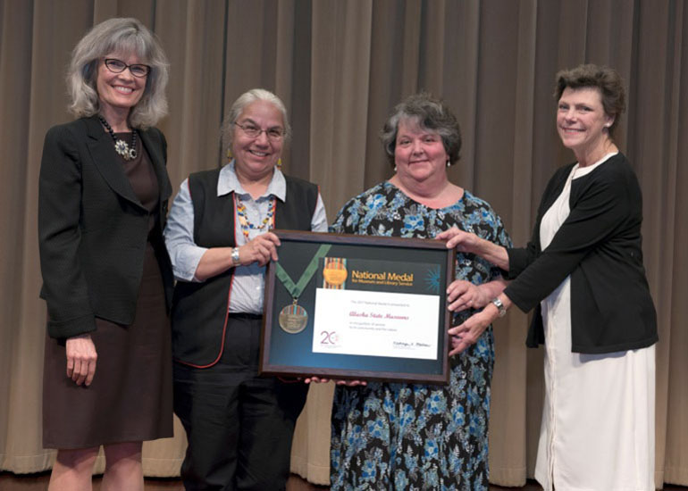 2017 National Medal recipient on stage with IMLS director and guest speaker