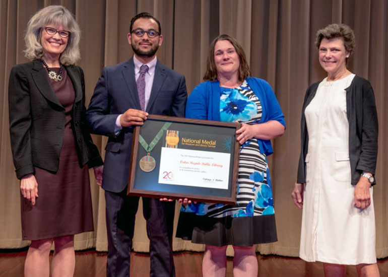 2017 National Medal recipient on stage with IMLS director and guest speaker