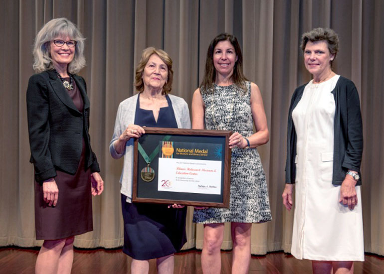 2017 National Medal recipient on stage with IMLS director and guest speaker