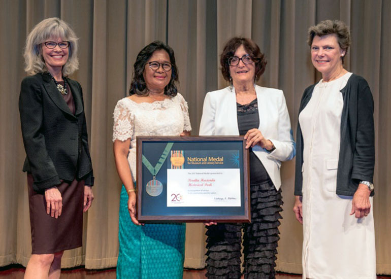 2017 National Medal recipient on stage with IMLS director and guest speaker