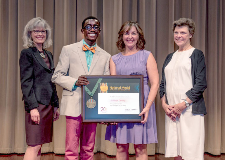 2017 National Medal recipient on stage with IMLS director and guest speaker