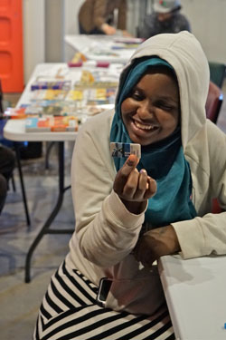 Teenage girl holding library card