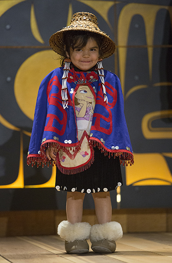 Toddler boy in traditional regalia.