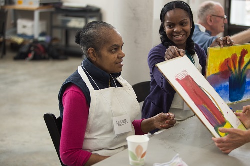 A mother and daughter present a work of art