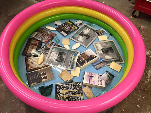 Workshop activity tub with water damaged material.