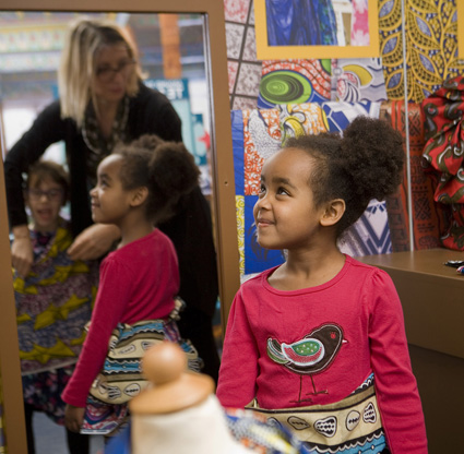 Families dress in the Senegalese fabrics in the tailor’s stall of the global marketplace of America to Zanzibar: Muslim Cultures Near and Far. Photo by: aommiephotography.com 