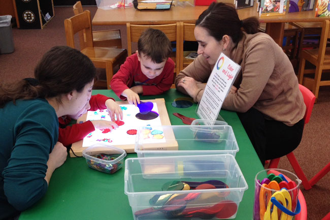 Kingdom of Why participants explore concepts using a light board and color paddles.