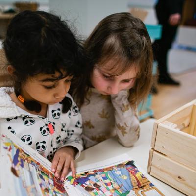 Two girls interacting with museum activity. Photo courtesy of Children’s Museum on Joint Base Lewis-McChord (JBLM)
