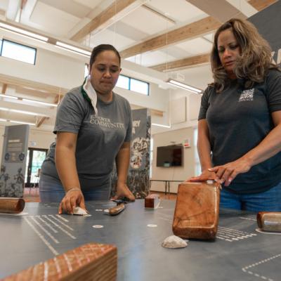 Kapa visitors pound clay (wauke) with an interactive display station.