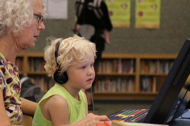 Child learning on accessible computer, Dakota County Library