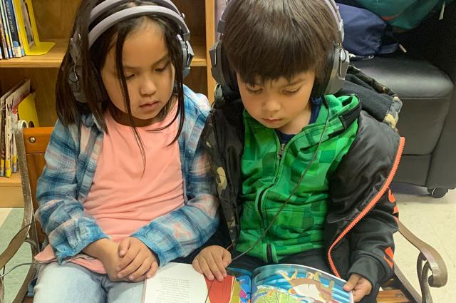 Students at the listening center in the children's library, Nooksack Tribal Library.