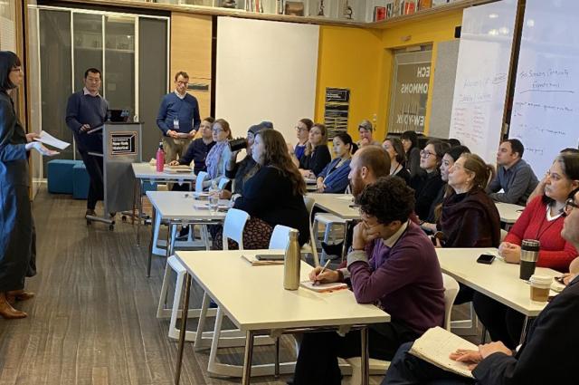 group of people sitting at tables during peer-to-peer training session