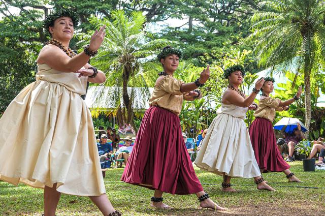 Women dressed in traditional clothes for a Hula performance.