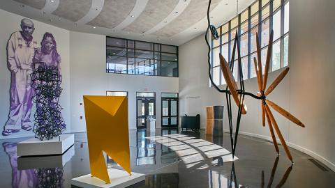 Museum lobby displaying artwork, sculptures and a wall mural. Photo courtesy of the El Paso Museum of Art.
