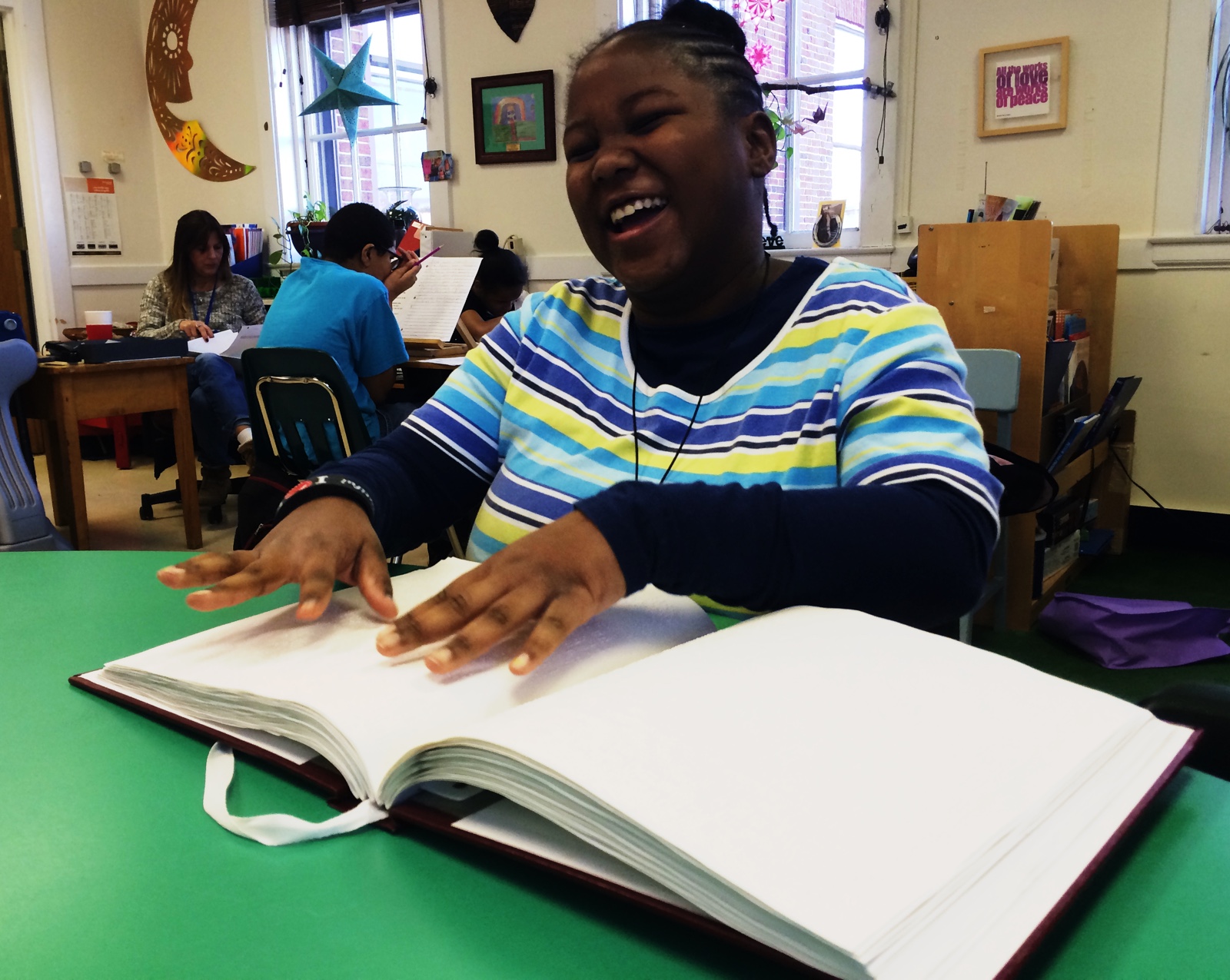 maryland library visitor reads Braille book