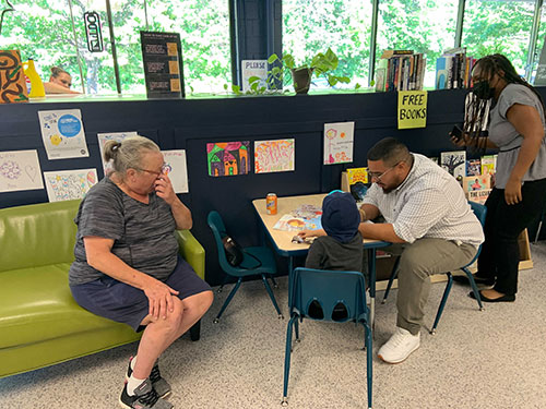 Wash and Learn library participants engage in table activity